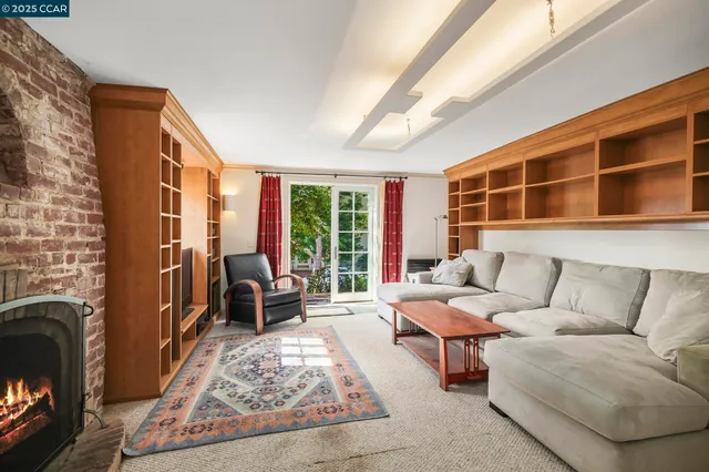 a living room with furniture a window and a fireplace