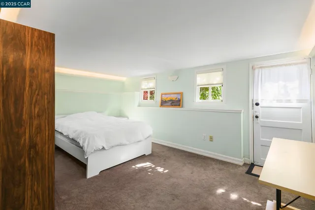 a spacious bedroom with a bed and a walk in closet