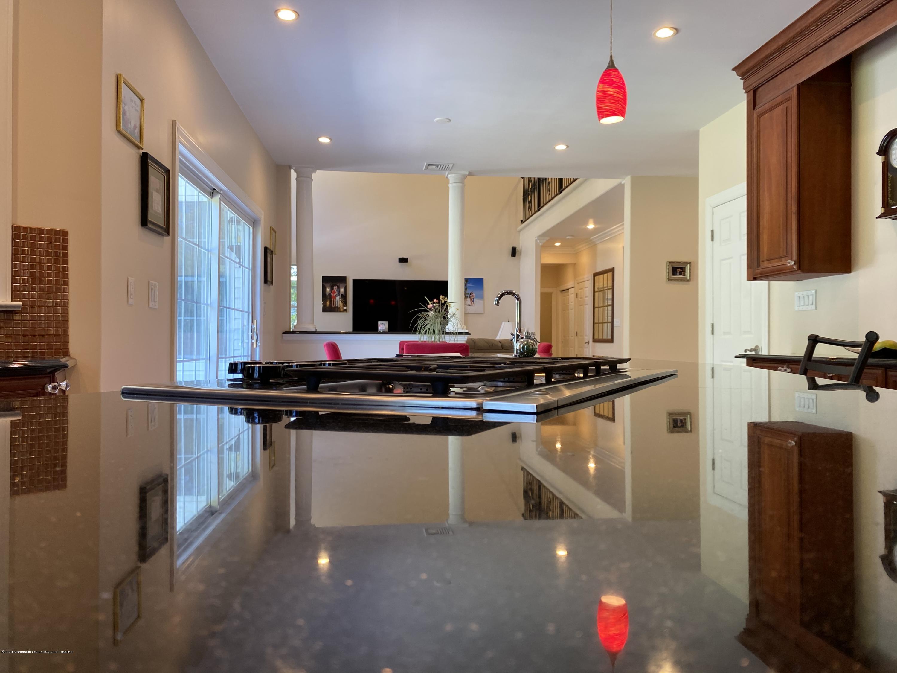 436 Stagecoach Road Millstone Township, NJ 08510 - Photo 33 of 97 a kitchen with stainless steel appliances granite countertop a sink stove and refrigerator