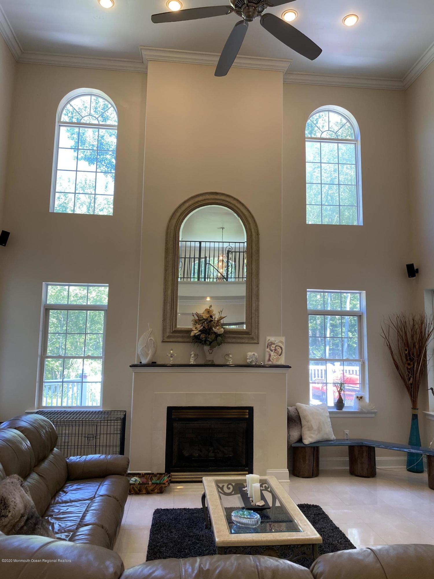 436 Stagecoach Road Millstone Township, NJ 08510 - Photo 39 of 97 a living room with furniture a window and a fireplace