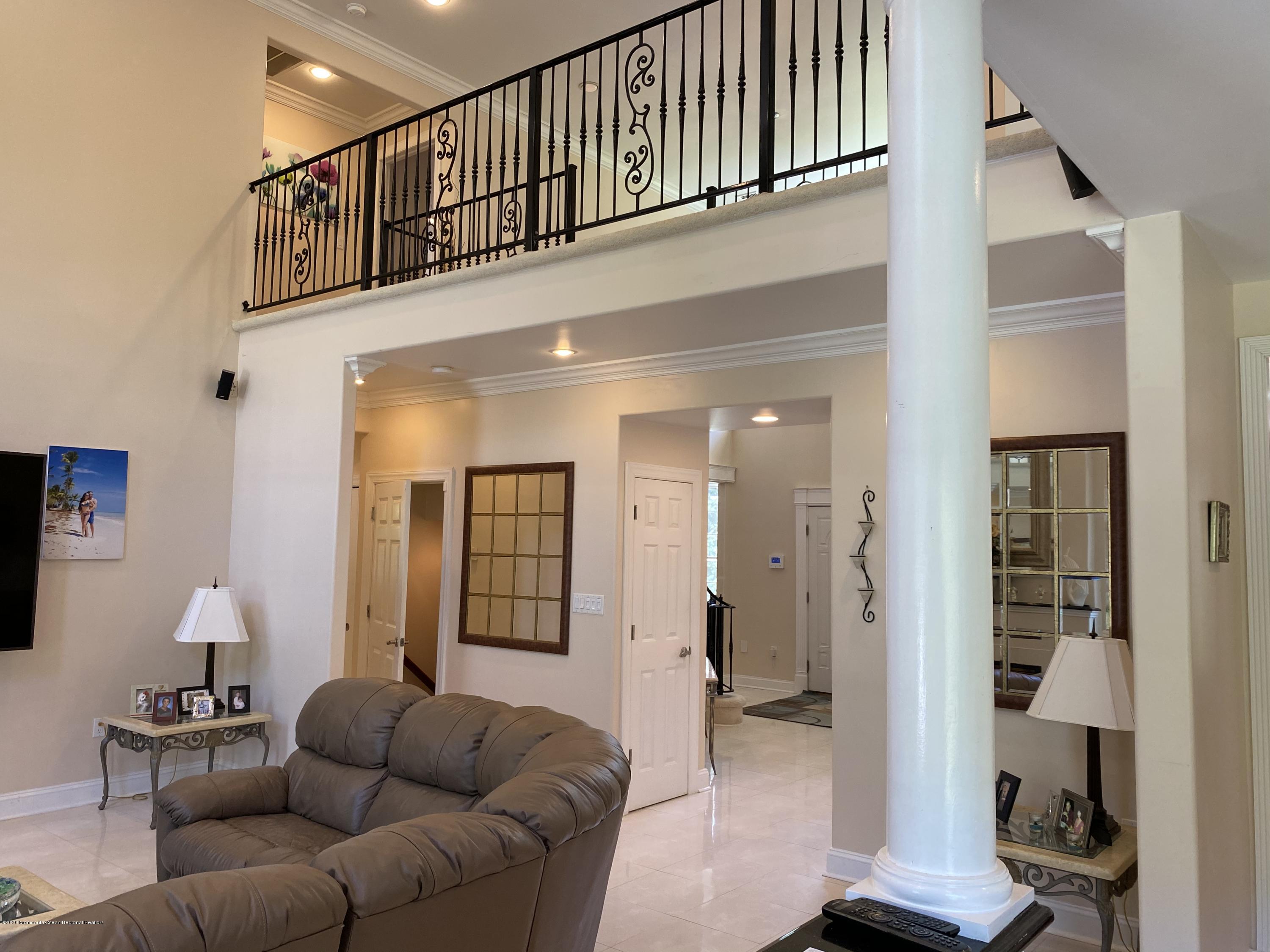 436 Stagecoach Road Millstone Township, NJ 08510 - Photo 40 of 97 a living room with furniture and a lamp