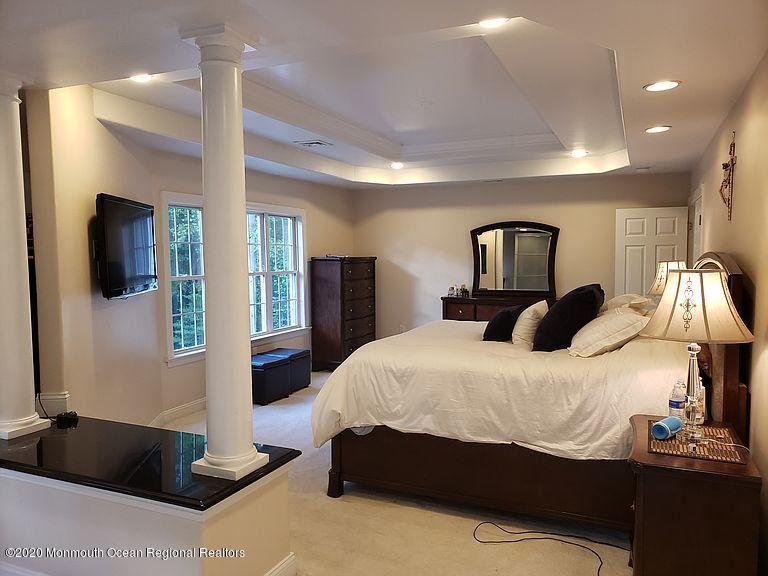 436 Stagecoach Road Millstone Township, NJ 08510 - Photo 49 of 97 a bedroom with a large bed and flat tv