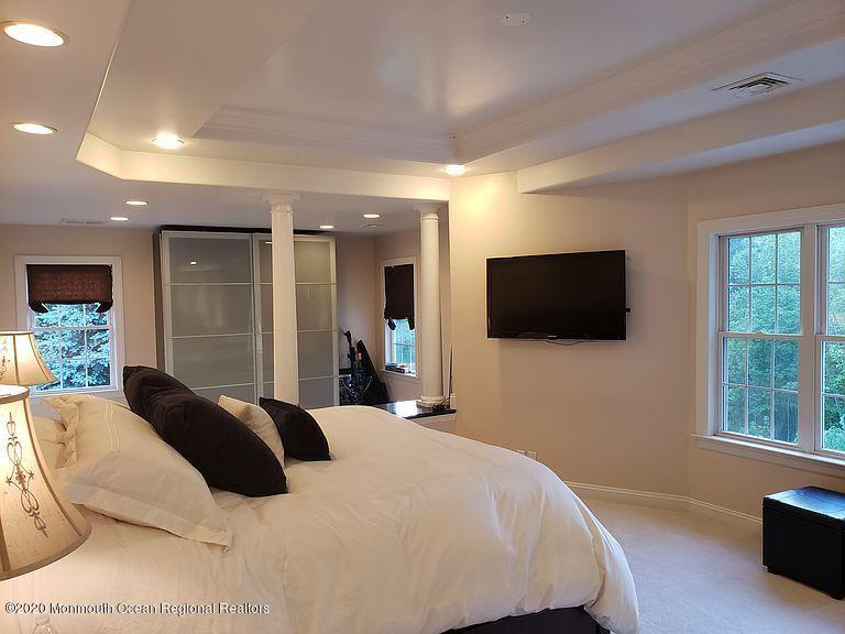 436 Stagecoach Road Millstone Township, NJ 08510 - Photo 50 of 97 a bedroom with a bed and a flat screen tv