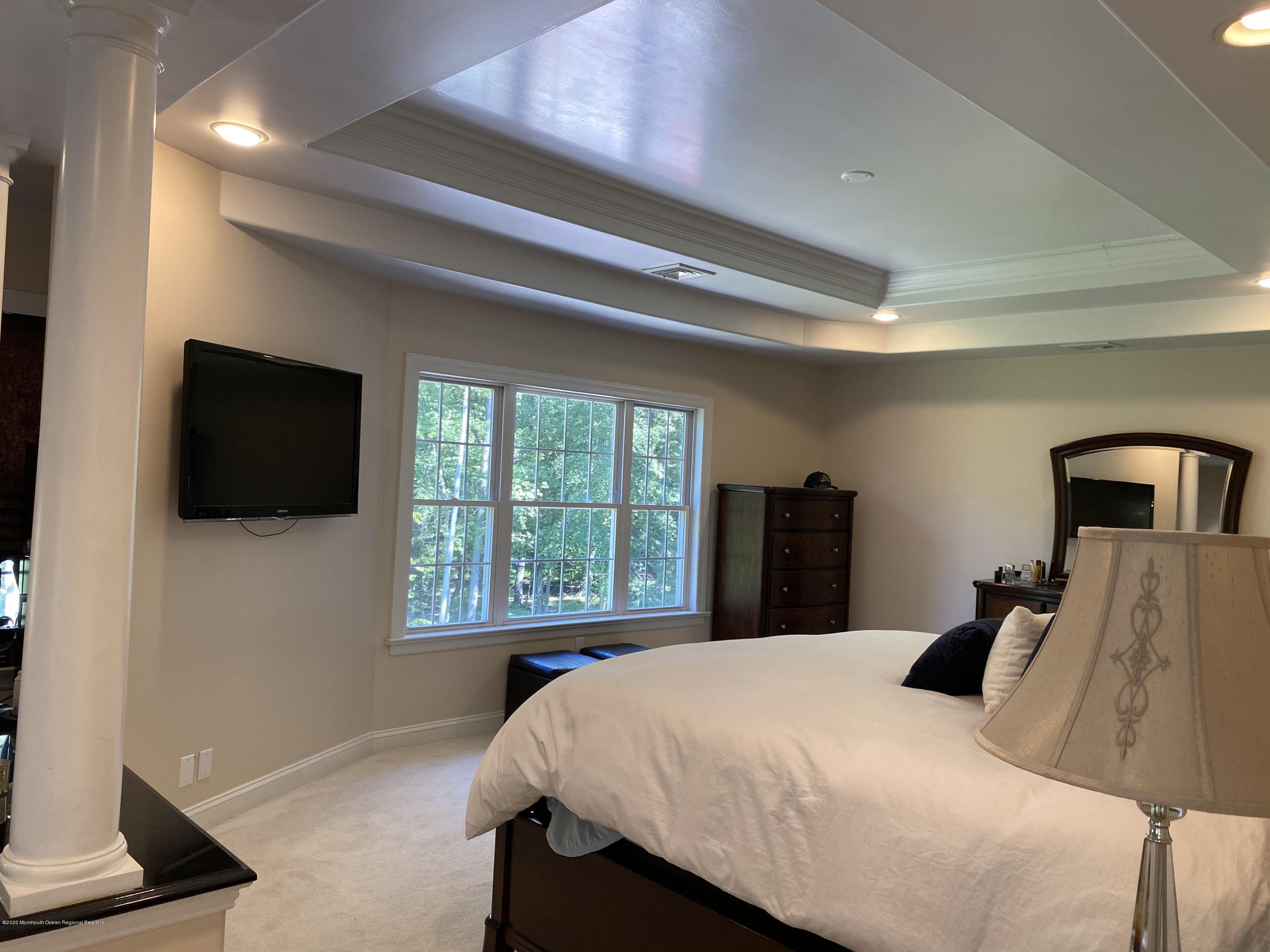 436 Stagecoach Road Millstone Township, NJ 08510 - Photo 52 of 97 a bedroom with a bed and a flat screen tv