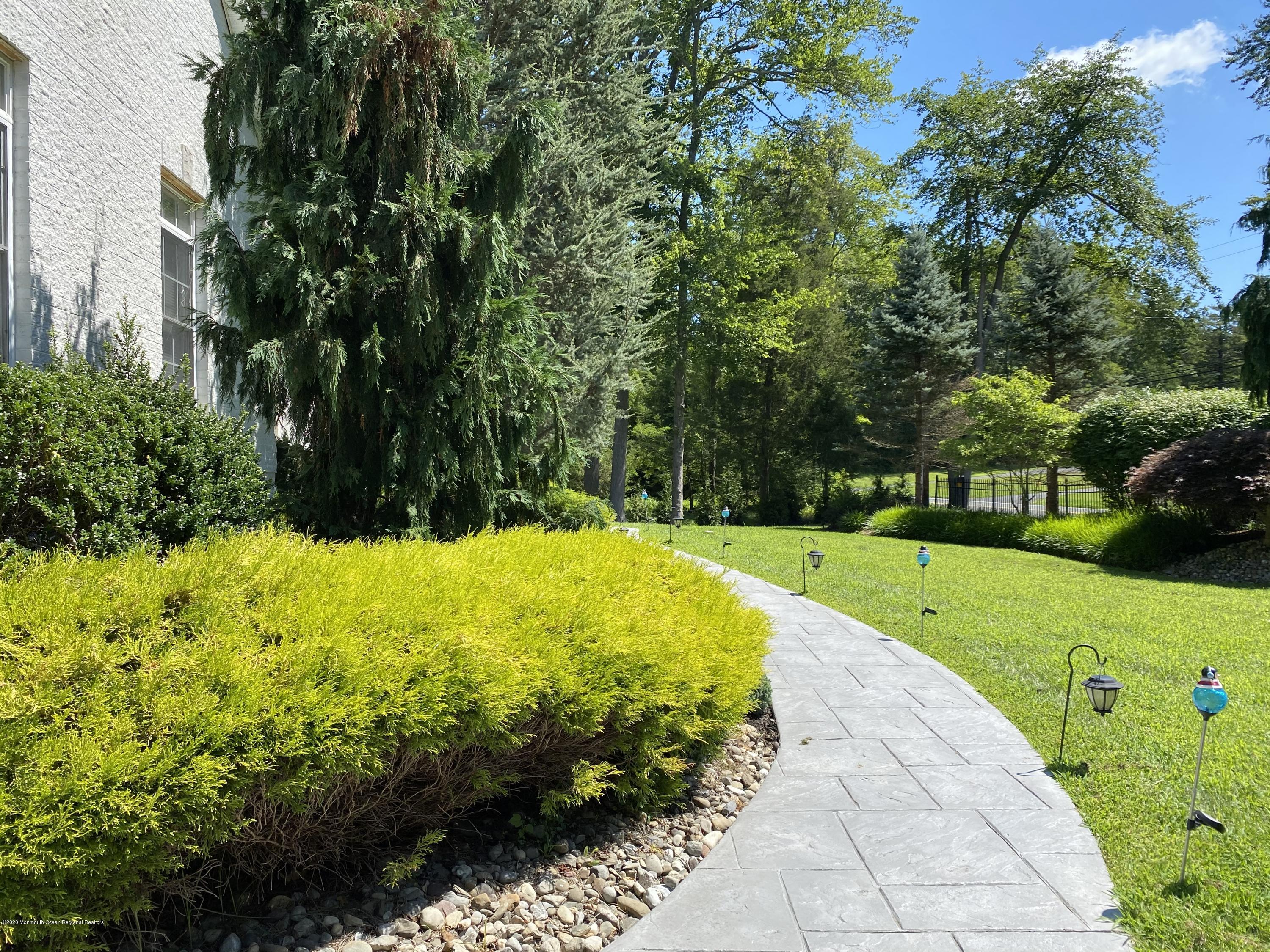 436 Stagecoach Road Millstone Township, NJ 08510 - Photo 8 of 97 a view of a swimming pool with a garden