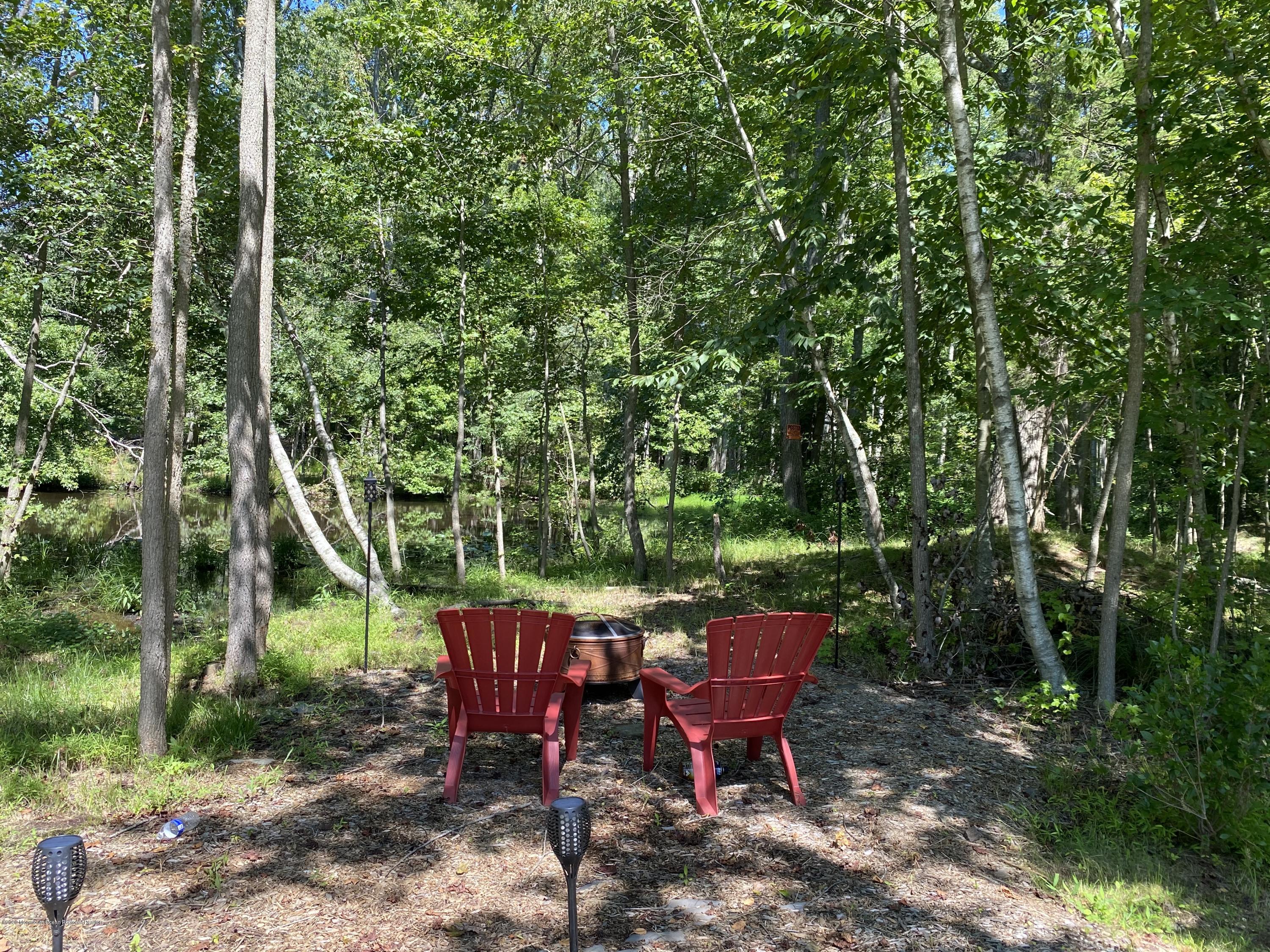 436 Stagecoach Road Millstone Township, NJ 08510 - Photo 80 of 97 a view of a sitting area with large trees