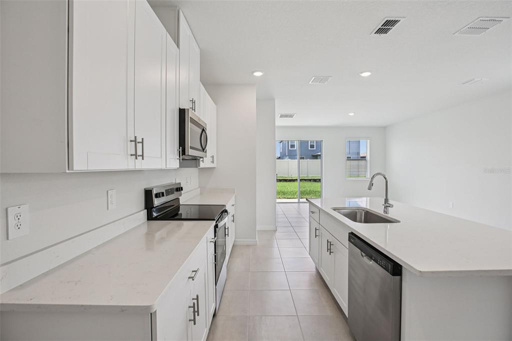 1820 Brekey Way Zephyrhills, FL 33541 - Photo 16 of 41 a kitchen with a sink stove and cabinets