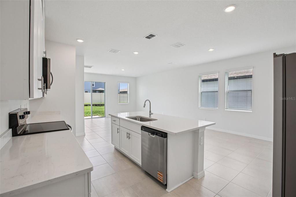 1820 Brekey Way Zephyrhills, FL 33541 - Photo 17 of 41 a kitchen with a sink dishwasher and white cabinets with wooden floor