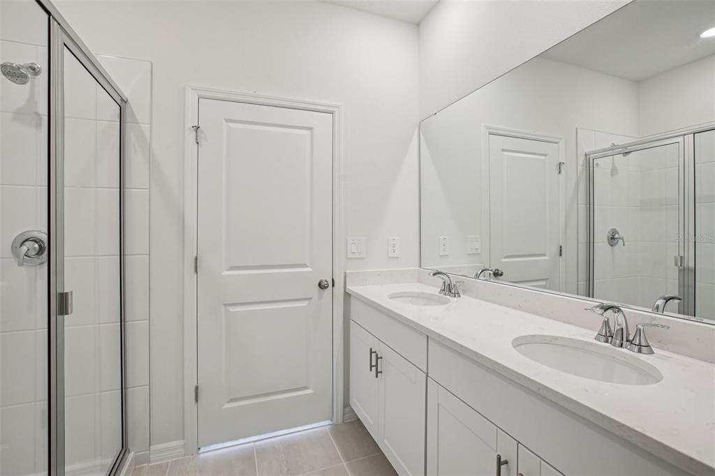 1820 Brekey Way Zephyrhills, FL 33541 - Photo 26 of 41 a bathroom with a double vanity sink and a mirror