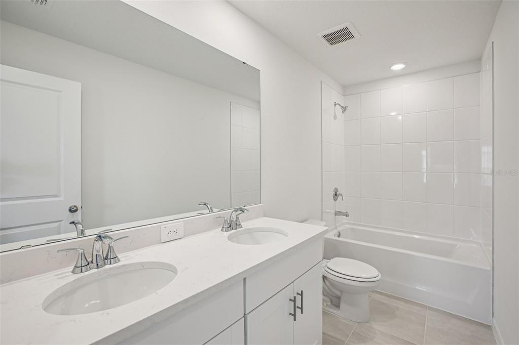 1820 Brekey Way Zephyrhills, FL 33541 - Photo 30 of 41 a bathroom with a sink a toilet and shower