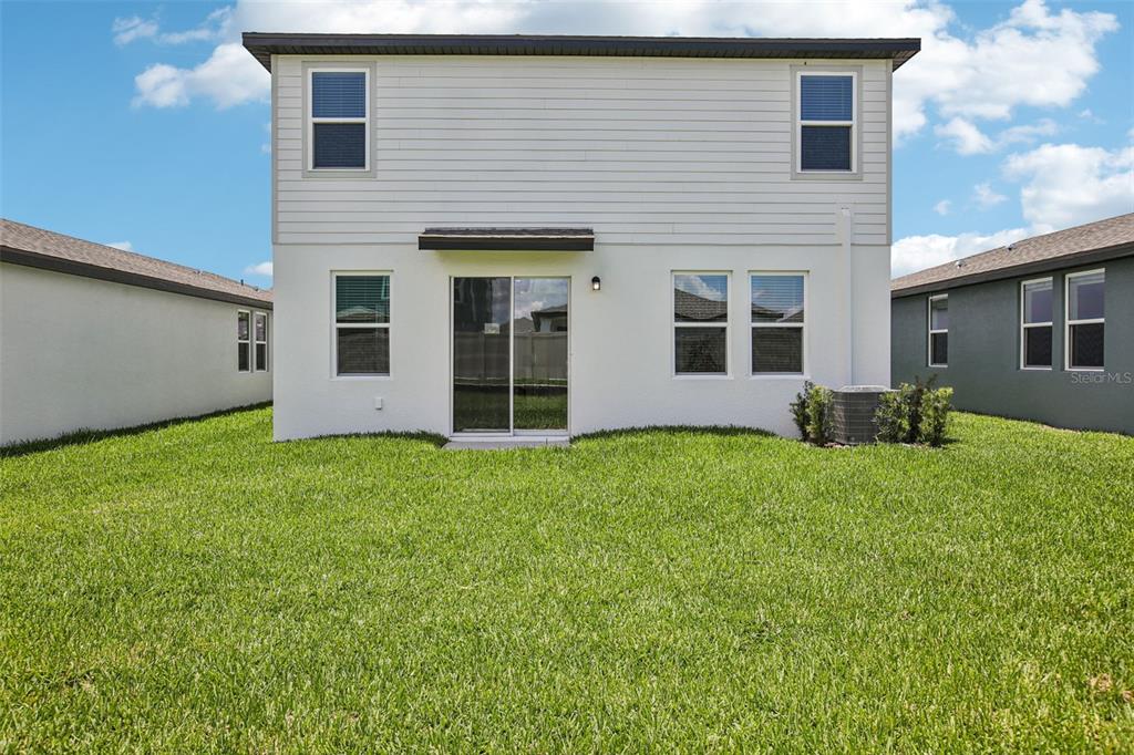 1820 Brekey Way Zephyrhills, FL 33541 - Photo 40 of 41 a view of a house with backyard