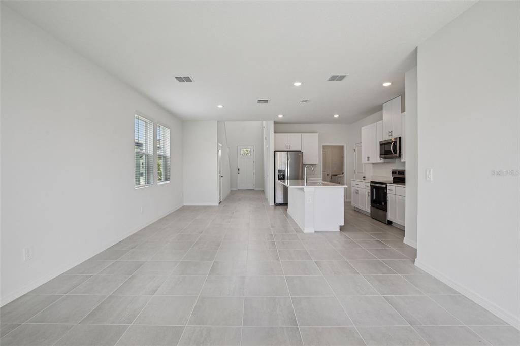 1820 Brekey Way Zephyrhills, FL 33541 - Photo 9 of 41 a view of a kitchen with refrigerator and white cabinets