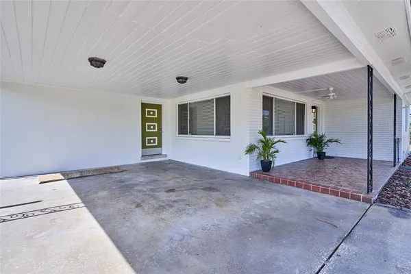 a view of a hallway with a potted plant in front of it