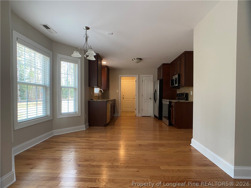 56 Orchard Falls Drive Spring Lake, NC 28390 - Photo 11 of 24 a view of a kitchen with refrigerator and windows