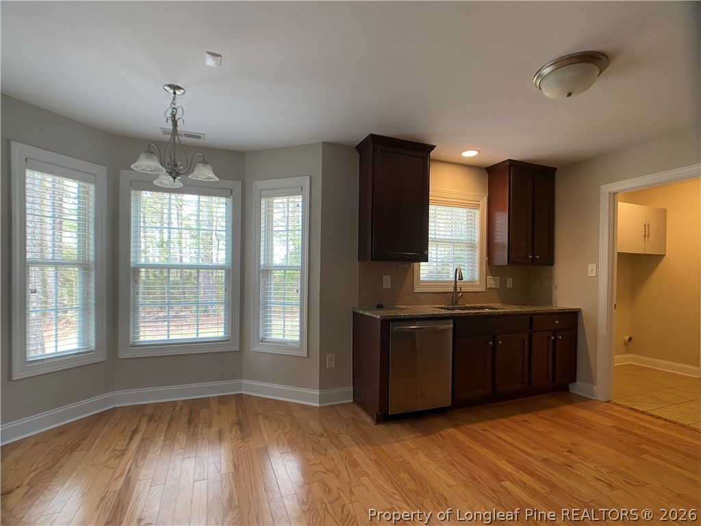 56 Orchard Falls Drive Spring Lake, NC 28390 - Photo 13 of 24 a view of kitchen with granite countertop cabinets and wooden floor