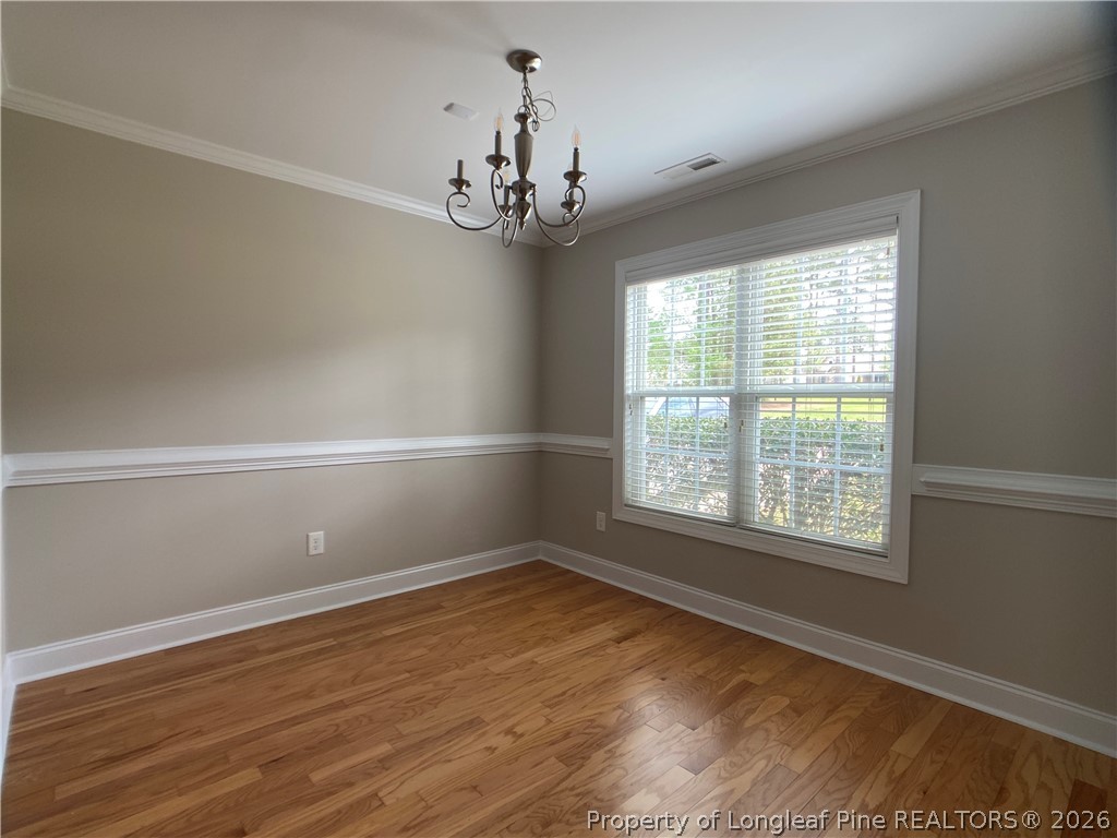 56 Orchard Falls Drive Spring Lake, NC 28390 - Photo 3 of 24 a view of an empty room with wooden floor and a window