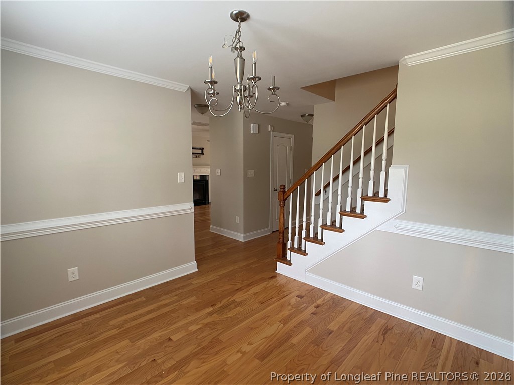 56 Orchard Falls Drive Spring Lake, NC 28390 - Photo 4 of 24 a view of a hallway with wooden floor and staircase