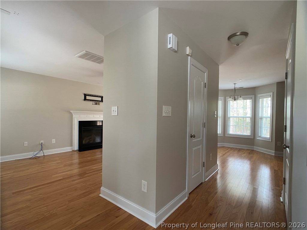56 Orchard Falls Drive Spring Lake, NC 28390 - Photo 5 of 24 a view of a hallway with wooden floor and staircase