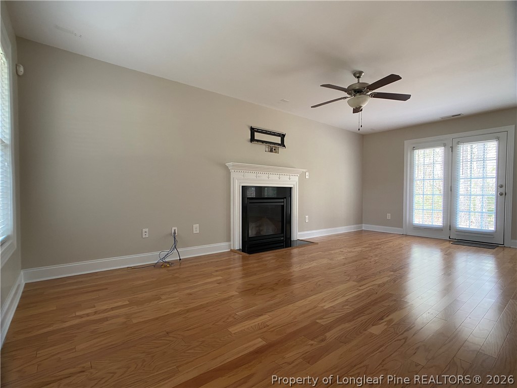 56 Orchard Falls Drive Spring Lake, NC 28390 - Photo 7 of 24 a view of empty room with wooden floor and fireplace