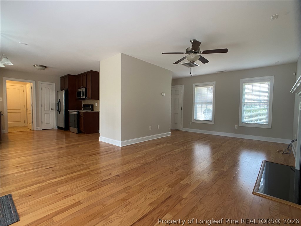 56 Orchard Falls Drive Spring Lake, NC 28390 - Photo 9 of 24 a view of an empty room with window and wooden floor