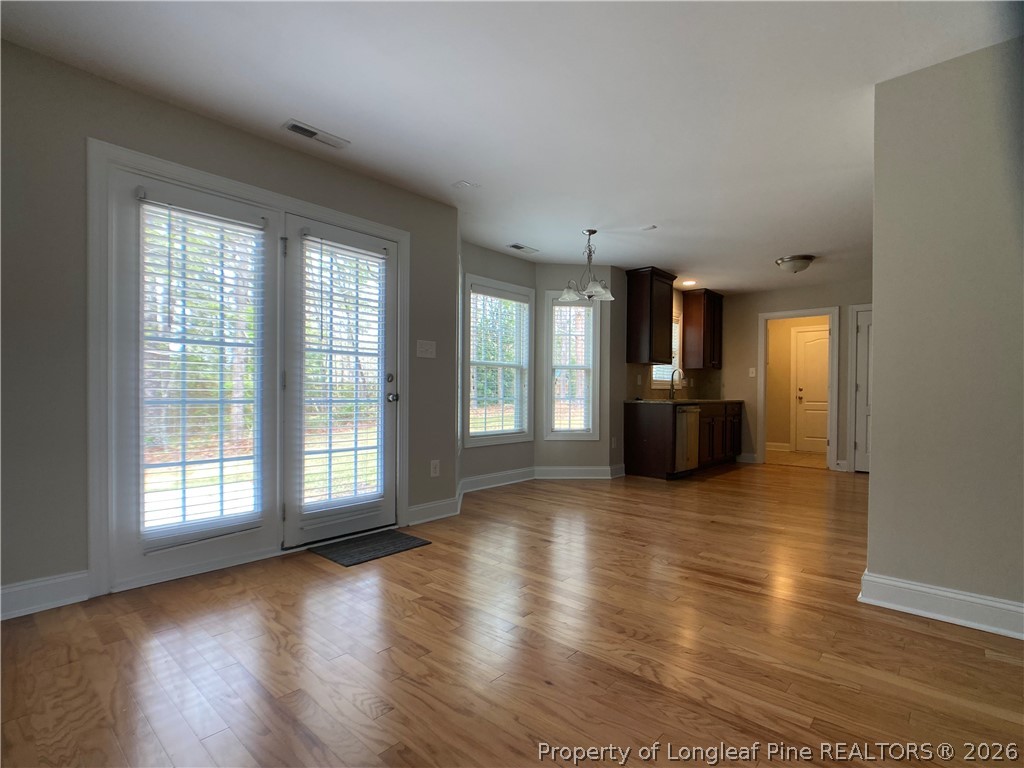 56 Orchard Falls Drive Spring Lake, NC 28390 - Photo 10 of 24 an empty room with wooden floor and windows