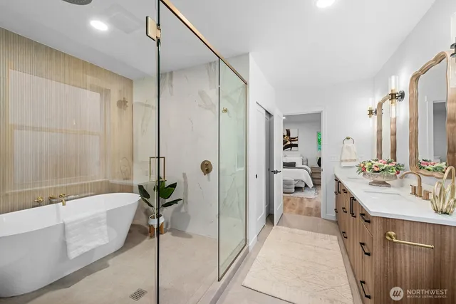 a spacious bathroom with a double vanity sink a mirror and a bathtub