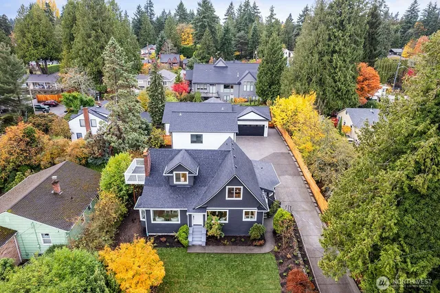 an aerial view of residential houses with outdoor space and trees