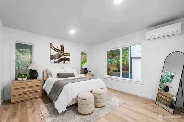 a bedroom with a bed and a large window