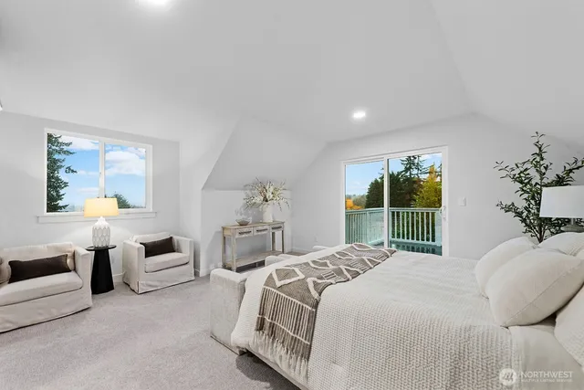 a bedroom with a large bed and a large window