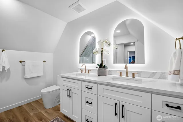 a bathroom with a double vanity sink and a mirror