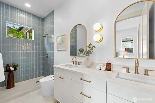 a bathroom with a toilet sink and mirror