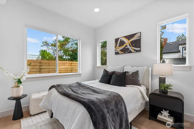 a bedroom with bed and a painting on the wall