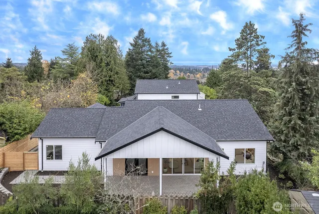 a aerial view of a house next to a yard