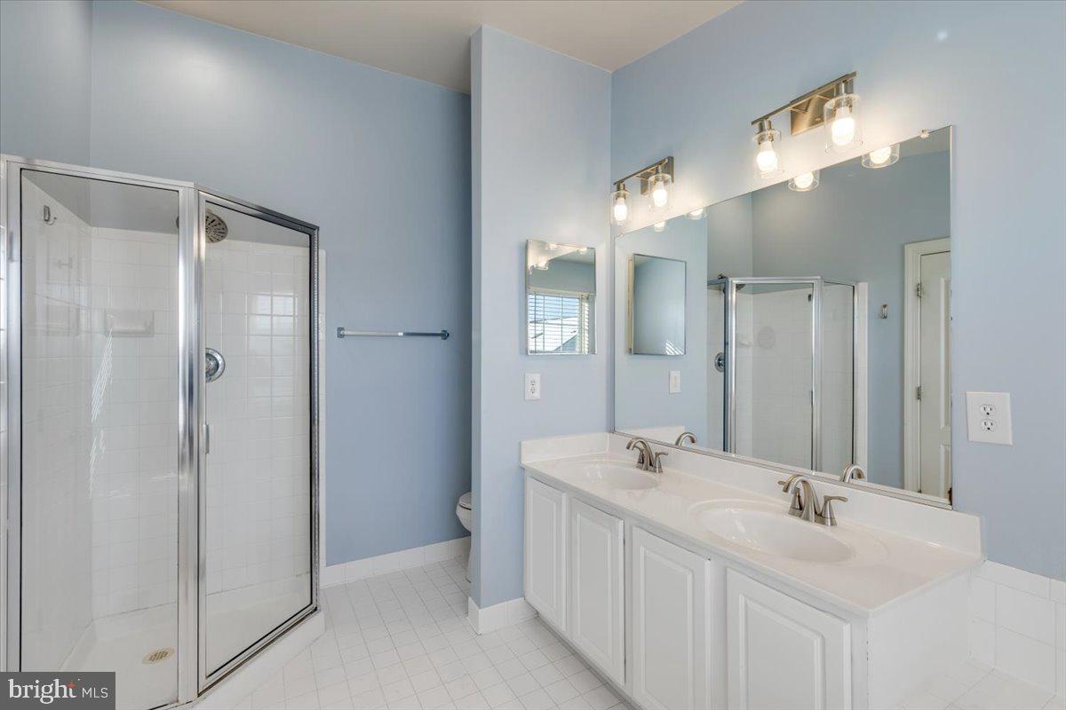 174 A Chevy Chase Street, Unit 174A Gaithersburg, MD 20878 - Photo 18 of 34 a bathroom with a double vanity sink mirror and shower