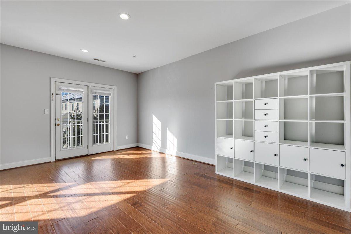 174 A Chevy Chase Street, Unit 174A Gaithersburg, MD 20878 - Photo 6 of 34 a view of an empty room with wooden floor and a window