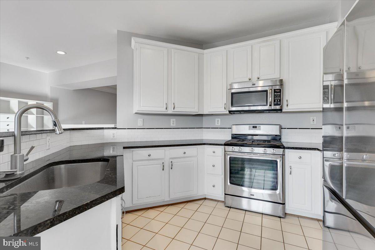 174 A Chevy Chase Street, Unit 174A Gaithersburg, MD 20878 - Photo 8 of 34 a kitchen with appliances a sink and cabinets