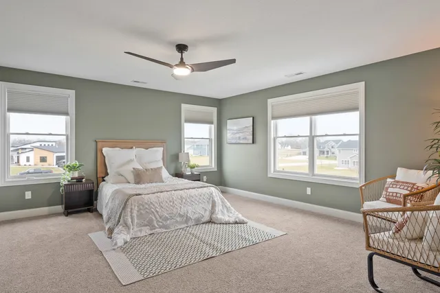 a spacious bathroom with a mirror a shower a sink and vanity