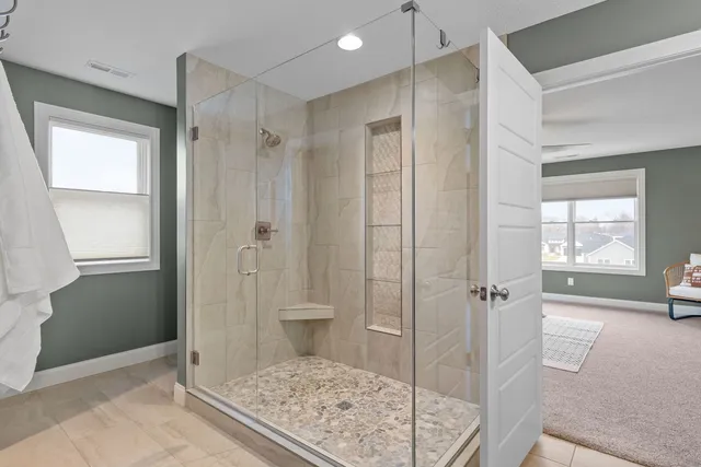 a bathroom with a granite countertop sink a toilet and a mirror