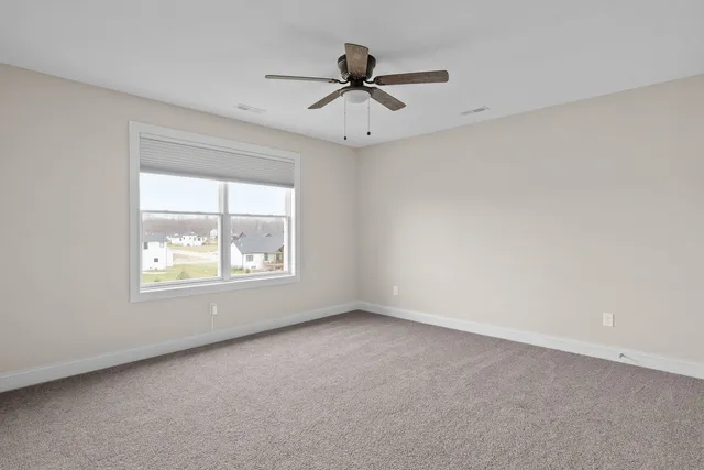 a bathroom with a toilet a sink a mirror and shower