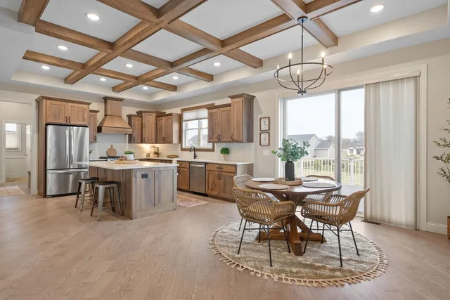 a view of a dining room with furniture and a chandelier