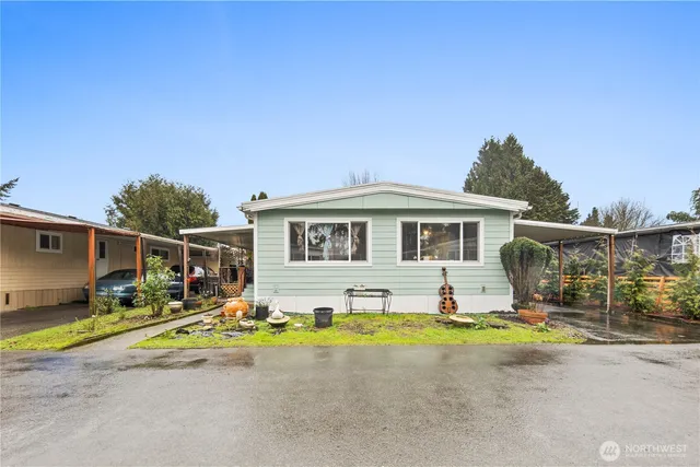 a view of house with swimming pool outdoor seating and house in the background