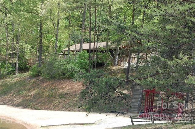 231 Amy Ridge Road Lake Lure, NC 28746 - Photo 10 of 23 a view of a yard with plants and large trees
