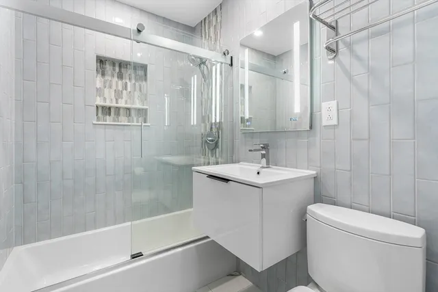 a bathroom with a sink toilet tub and shower