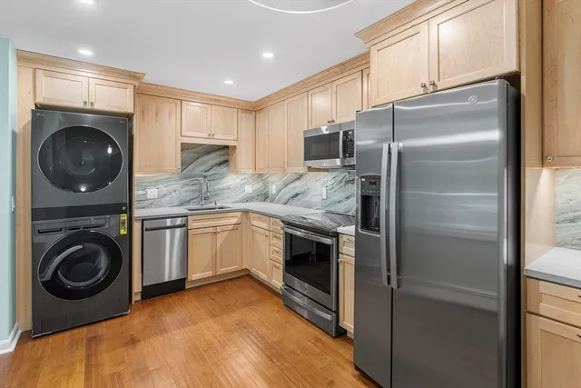 a kitchen with a refrigerator sink and cabinets