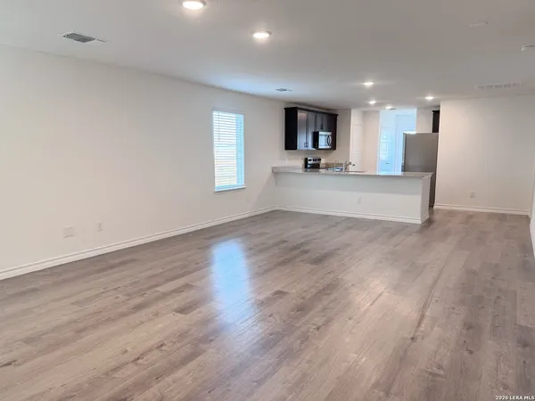 a view of kitchen with wooden floor and window