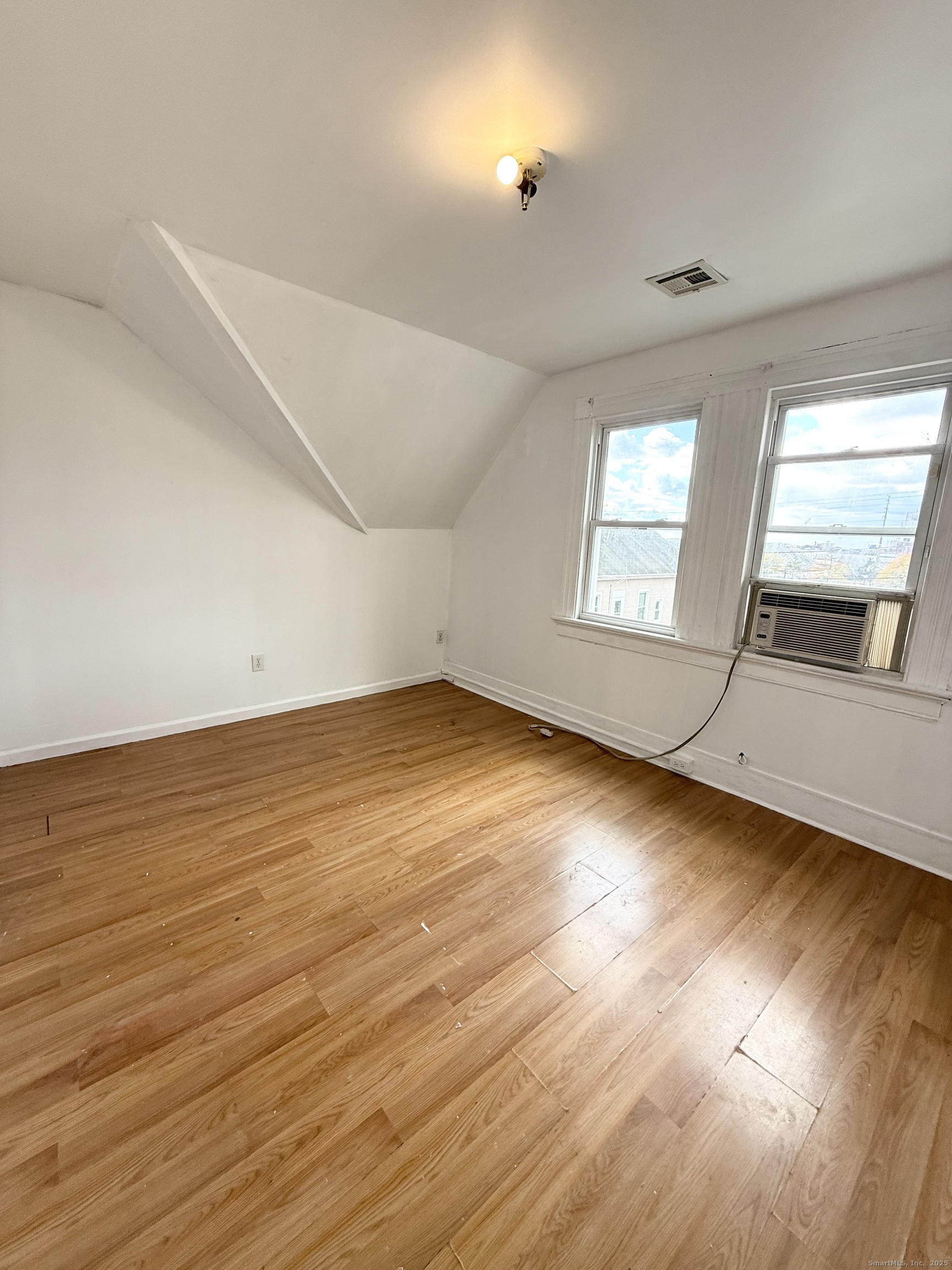 342 Exchange Street New Haven, CT 06513 - Photo 9 of 9 an empty room with wooden floor and windows