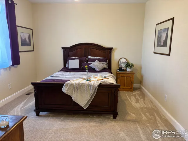 a bedroom with a bed and flat screen tv