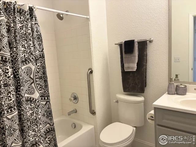 a bathroom with a sink mirror and toilet