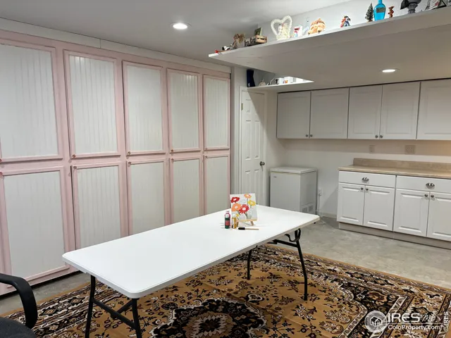 a kitchen with a table chairs and a refrigerator