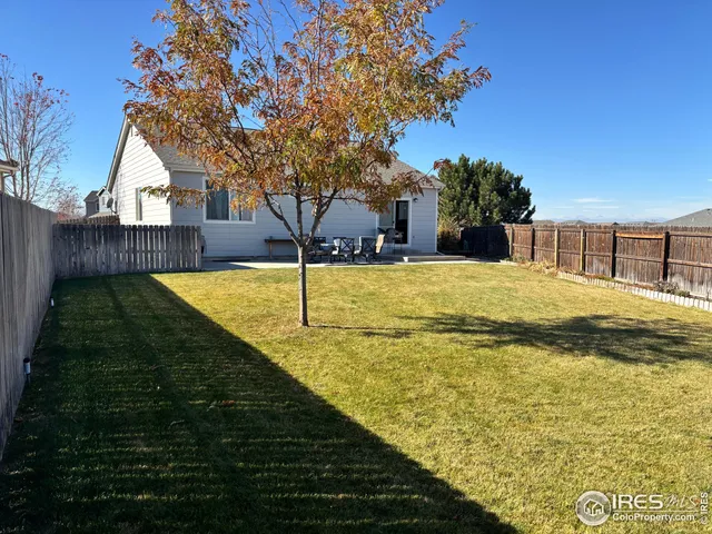 a view of swimming pool with outdoor seating and yard in the back